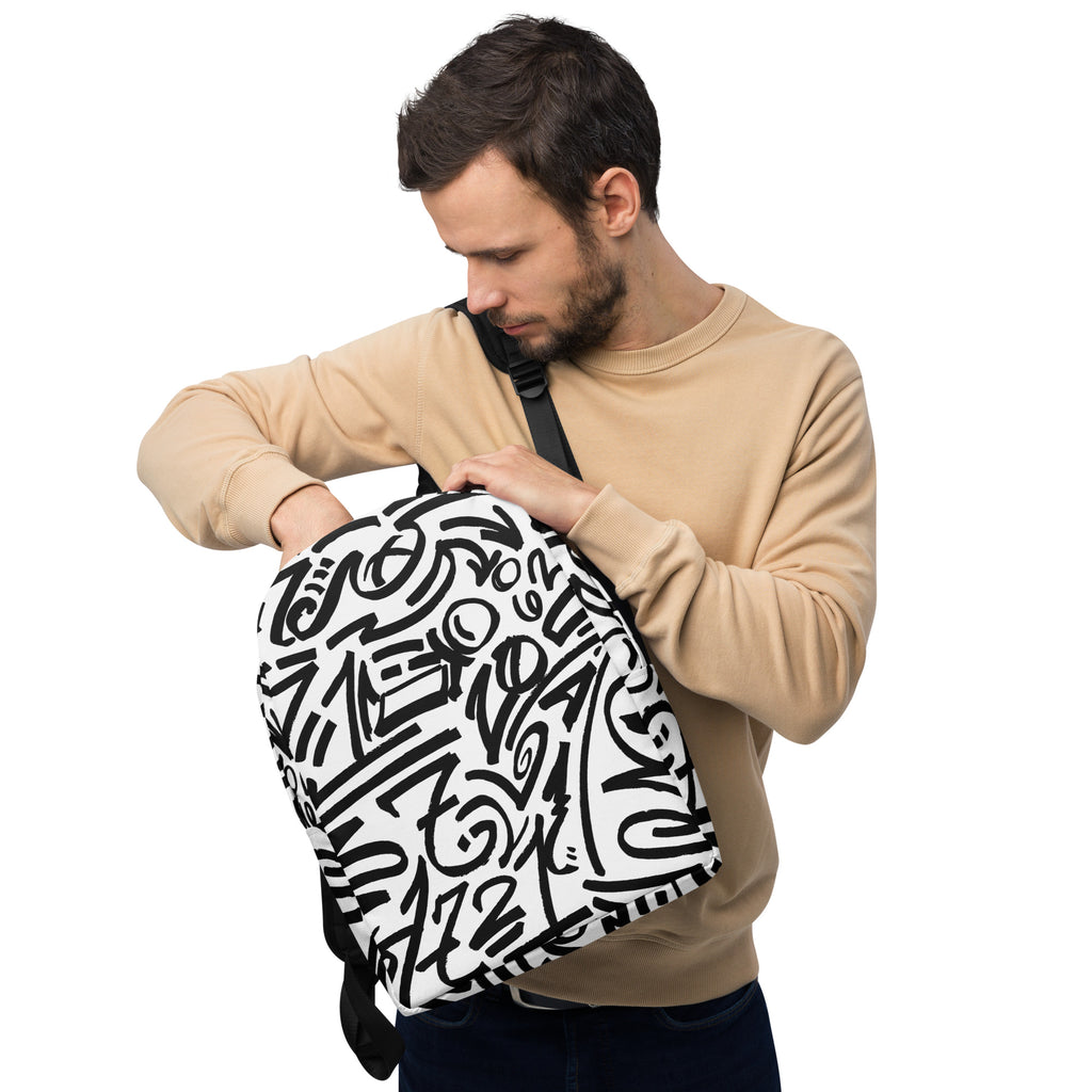 Man holding the glyph backpack open at the top zip, front panel of black marks facing out