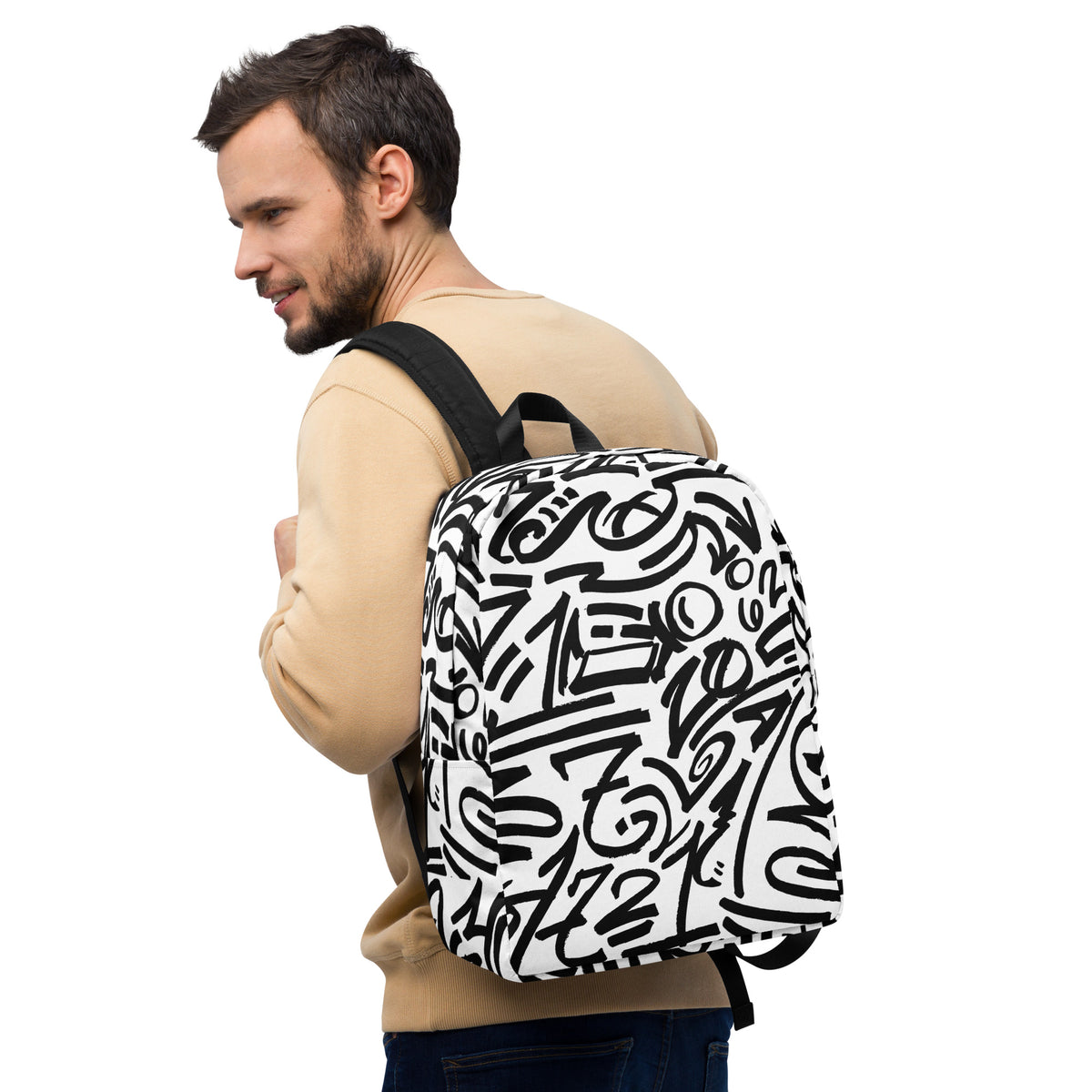 Man in a tan sweatshirt carrying the glyph backpack on one shoulder, seen from his right