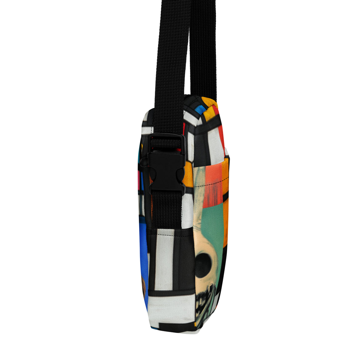 Right edge of the crossbody bag with its side-release buckle, skull fragment along the seam