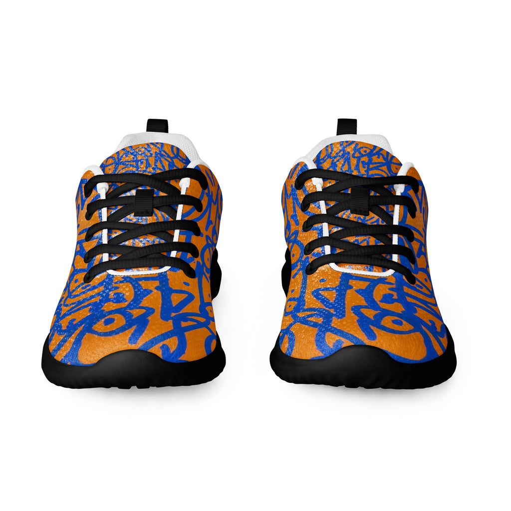 Orange athletic shoes covered in cobalt graffiti glyphs, black soles and black laces, front view